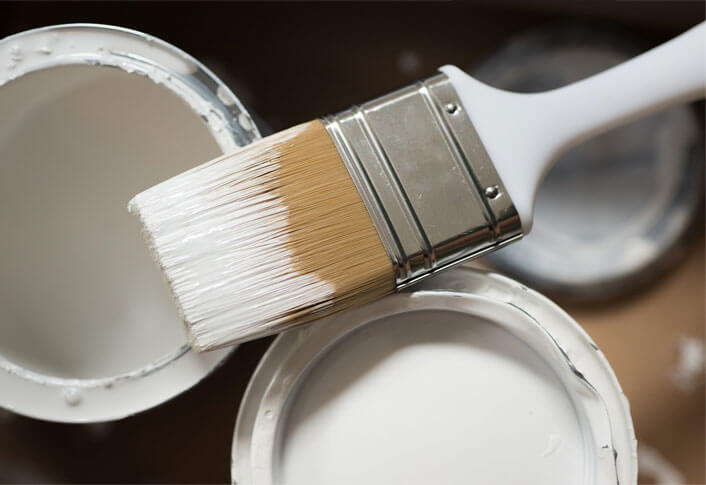 Paint brush and white color paint bucket